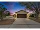 Beige house with brown garage door at dusk; nice curb appeal at 11206 Silver Fern Way, Riverview, FL 33569