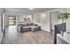 Living room with grey sectional sofa and wood-look floors at 11206 Silver Fern Way, Riverview, FL 33569