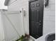 Image focusing on a back entrance, featuring a solid door and security details at 12368 70Th St, Largo, FL 33773