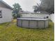 View of the backyard with above ground pool and grass at 12368 70Th St, Largo, FL 33773