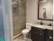 Bathroom features include a tiled shower, a granite countertop, and dark wood cabinetry at 12368 70Th St, Largo, FL 33773