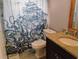 Nautical themed bathroom featuring stylish vanity with granite countertop and ship shower curtain at 12368 70Th St, Largo, FL 33773