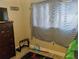 Bedroom featuring dresser, window with striped curtains, and wood-look flooring at 12368 70Th St, Largo, FL 33773