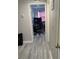 Hallway leads to brightly lit computer room with wood-look flooring at 12368 70Th St, Largo, FL 33773