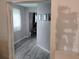 Hallway featuring gray wood-look flooring, walls in progress, and a view into another room at 12368 70Th St, Largo, FL 33773