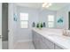 Elegant bathroom with double vanity, bright lighting and modern fixtures at 12625 Horseshoe Bend Dr, Lithia, FL 33547