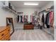 Spacious walk-in closet with ample storage, shelving and mirrored accents at 12625 Horseshoe Bend Dr, Lithia, FL 33547