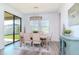 Bright dining room featuring modern lighting, a stylish rug, and sliding glass doors to the patio at 12625 Horseshoe Bend Dr, Lithia, FL 33547