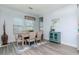 Elegant dining room with a modern light fixture, light wood table and accent hutch at 12625 Horseshoe Bend Dr, Lithia, FL 33547