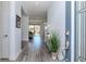 Inviting entryway with stylish gray wood floors, a decorative plant, and a view of the living area in the background at 12625 Horseshoe Bend Dr, Lithia, FL 33547