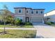 Two-story home showcasing well-maintained landscaping, complemented by a neatly manicured lawn and a driveway leading to an attached garage at 12625 Horseshoe Bend Dr, Lithia, FL 33547