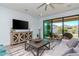 Cozy living room featuring a large screen TV, modern furniture and sliding glass doors to the patio at 12625 Horseshoe Bend Dr, Lithia, FL 33547