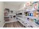 Spacious walk-in pantry featuring white wire shelving and wood-look flooring providing ample storage at 12625 Horseshoe Bend Dr, Lithia, FL 33547