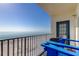 A balcony with ocean views featuring Adirondack chairs and access to the beach at 13500 Gulf Blvd # 702, Madeira Beach, FL 33708