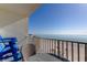 Condo balcony featuring a table and chairs with ocean views and access to the beach at 13500 Gulf Blvd # 702, Madeira Beach, FL 33708