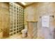 Nicely remodeled bathroom featuring glass block shower and tiled walls at 13500 Gulf Blvd # 702, Madeira Beach, FL 33708