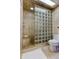 Nicely remodeled bathroom featuring glass block shower, toilet and tiled walls at 13500 Gulf Blvd # 702, Madeira Beach, FL 33708