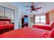 Comfortable bedroom with two beds, mirrored closet doors, and a ceiling fan, creating a relaxing atmosphere at 13500 Gulf Blvd # 702, Madeira Beach, FL 33708