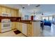 Open concept kitchen with tile floors offering views of the living room and ocean beyond at 13500 Gulf Blvd # 702, Madeira Beach, FL 33708