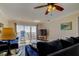 Comfortable living room with ocean view, plush blue sofas, and access to a private balcony at 13500 Gulf Blvd # 702, Madeira Beach, FL 33708