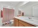 Bathroom featuring a neutral color scheme, bath towels, toilet, and shower with strawberry curtain at 13526 Palmera Vista Dr, Riverview, FL 33579