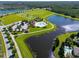 Picturesque aerial view of the community pool, tennis courts, and other recreational facilities at 13526 Palmera Vista Dr, Riverview, FL 33579