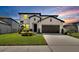 Beautiful two-story home features a manicured lawn, a two car garage, and a modern white facade at 13526 Palmera Vista Dr, Riverview, FL 33579