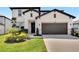 Charming two-story home showcasing a well-manicured lawn and an attached two-car garage at 13526 Palmera Vista Dr, Riverview, FL 33579