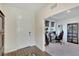 Inviting foyer with wood-look tile, leading to a home office with a desk and gaming chair at 13526 Palmera Vista Dr, Riverview, FL 33579