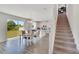 Open kitchen and dining area with tile floors, white cabinets, and a glass door to the backyard at 13526 Palmera Vista Dr, Riverview, FL 33579