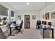 Bright home office with dual monitors, a gaming chair, and natural light from the window at 13526 Palmera Vista Dr, Riverview, FL 33579