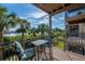 Relaxing balcony with a table and chairs overlooking lush greenery and water at 1442 Harbour Walk Rd, Tampa, FL 33602