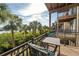 Private balcony with seating area offering views of tropical palm trees and waterfront at 1442 Harbour Walk Rd, Tampa, FL 33602