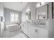 Luxurious bathroom with a freestanding tub, dual vanities, and elegant fixtures at 1442 Harbour Walk Rd, Tampa, FL 33602