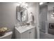 Well-lit bathroom featuring a marble-topped vanity with white cabinets and stylish mirror at 1442 Harbour Walk Rd, Tampa, FL 33602