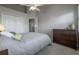 Cozy bedroom featuring neutral walls and carpet, a ceiling fan, and a wooden dresser at 1442 Harbour Walk Rd, Tampa, FL 33602