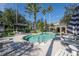 Beautiful community pool with lounge area, cabana, palm trees and a building for residents at 1442 Harbour Walk Rd, Tampa, FL 33602