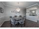 Elegant dining room with chandelier, gray walls, and an adjacent mirrored wall at 1442 Harbour Walk Rd, Tampa, FL 33602