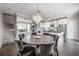 Elegant dining room with modern chandelier, hardwood floors, and staircase access at 1442 Harbour Walk Rd, Tampa, FL 33602