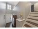 Open entryway featuring wood floors, bench and coat rack, with staircase to upper level at 1442 Harbour Walk Rd, Tampa, FL 33602