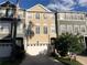 Three-story townhome featuring neutral color palette and attached one car garage at 1442 Harbour Walk Rd, Tampa, FL 33602