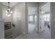 Bright hallway features modern light fixture and neutral carpeting leading to bedrooms with plantation shutters at 1442 Harbour Walk Rd, Tampa, FL 33602