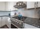 Modern stainless steel stove with light blue backsplash in a bright white kitchen at 1442 Harbour Walk Rd, Tampa, FL 33602