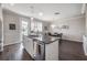 Kitchen island featuring a stainless steel sink and an open design looking into the dining room at 1442 Harbour Walk Rd, Tampa, FL 33602