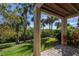 Inviting covered patio offers a private outdoor space with views of mature trees and greenery at 1442 Harbour Walk Rd, Tampa, FL 33602