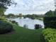 Scenic view of a community pond with fountains, surrounded by well-manicured lawns at 1442 Harbour Walk Rd, Tampa, FL 33602