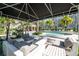 Relaxing pool area with comfortable seating, palm trees, and lush landscaping at 1442 Harbour Walk Rd, Tampa, FL 33602