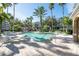 Inviting community pool surrounded by palm trees and lounge chairs, perfect for relaxation at 1442 Harbour Walk Rd, Tampa, FL 33602