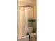 Bathroom showcasing a white shower curtain, toilet, and cabinet for essential bathroom storage at 145 10Th N Ave # 8, St Petersburg, FL 33701