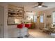 Bright kitchen featuring a breakfast bar with two red stools and open shelving for ample storage at 145 10Th N Ave # 8, St Petersburg, FL 33701